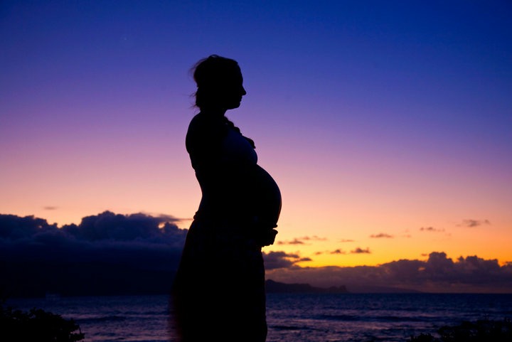 preparing for pregnancy pregnant woman in front of sunset