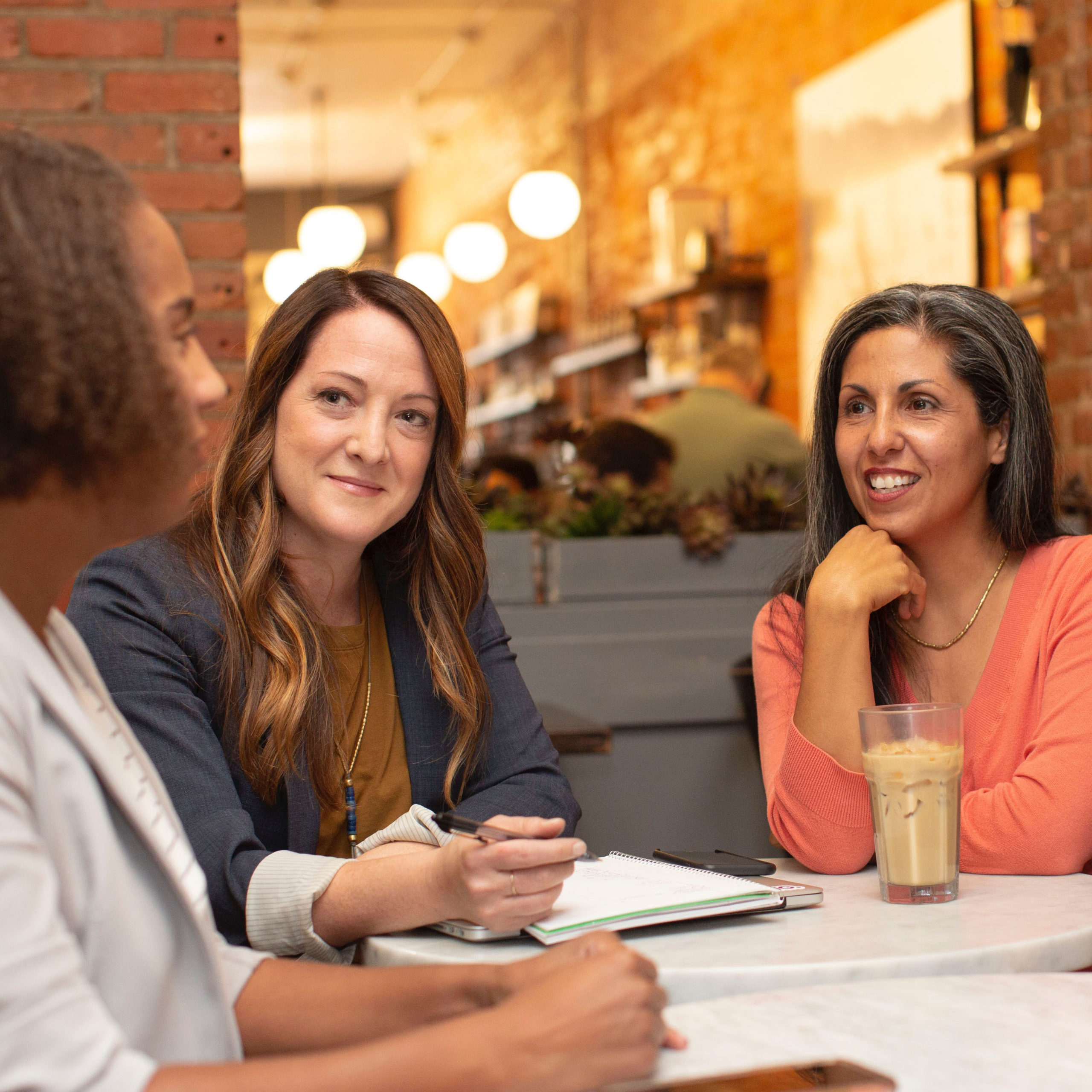 women sitting at table talking