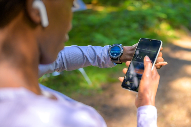 person syncing their smart watch with the phone for a run